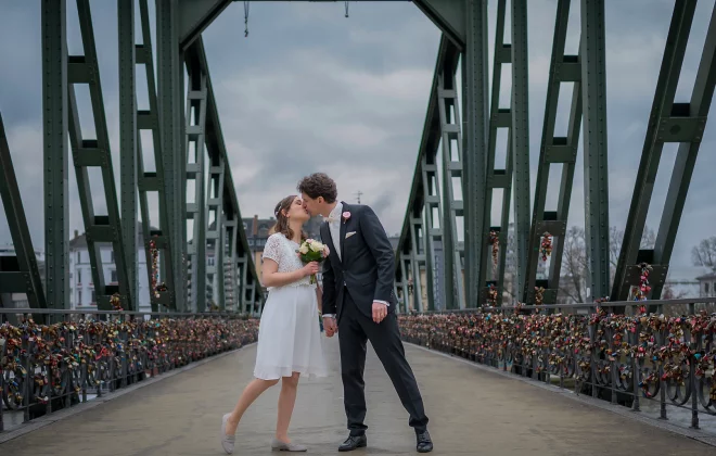 Ein Brautpaar küsst sich auf der alten Brücke in Frankfurt am Main