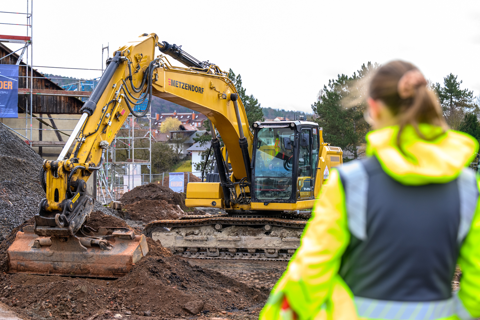 Baggerfahrerin steuert einen Bagger auf der Baustelle