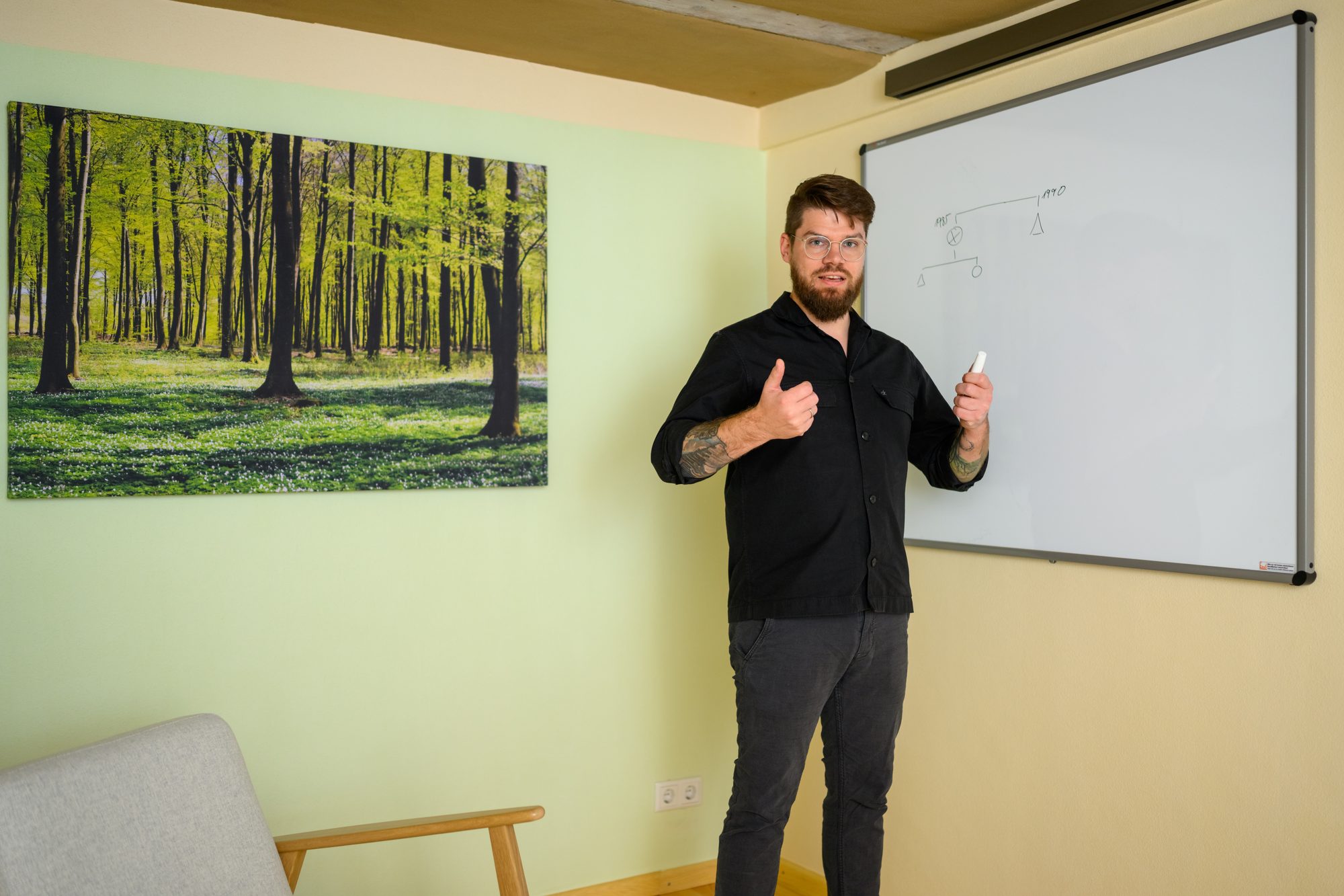 Ronny Mosebach steht am Whiteboard und spricht in Richtung Kamera